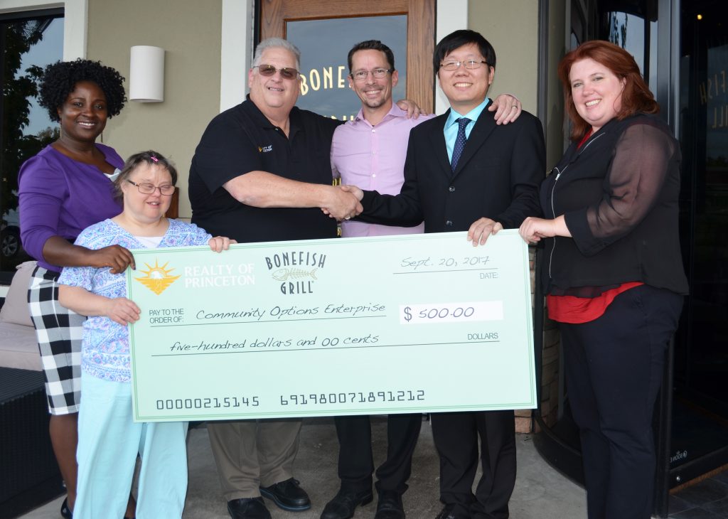 Left to right: Ida Bormentar, Executive Director Community Options; Mary; James A. McKenna, Broker/Owner for Realty of Princeton; Christopher Wilkerson, Managing Partner of BoneFish Grill; Andrew Park, Managing Director of Community Options Enterprises; Melissa Alancourt, Director of Floral Operations for Community Options Enterprises' Vaseful Flowers & Gifts.