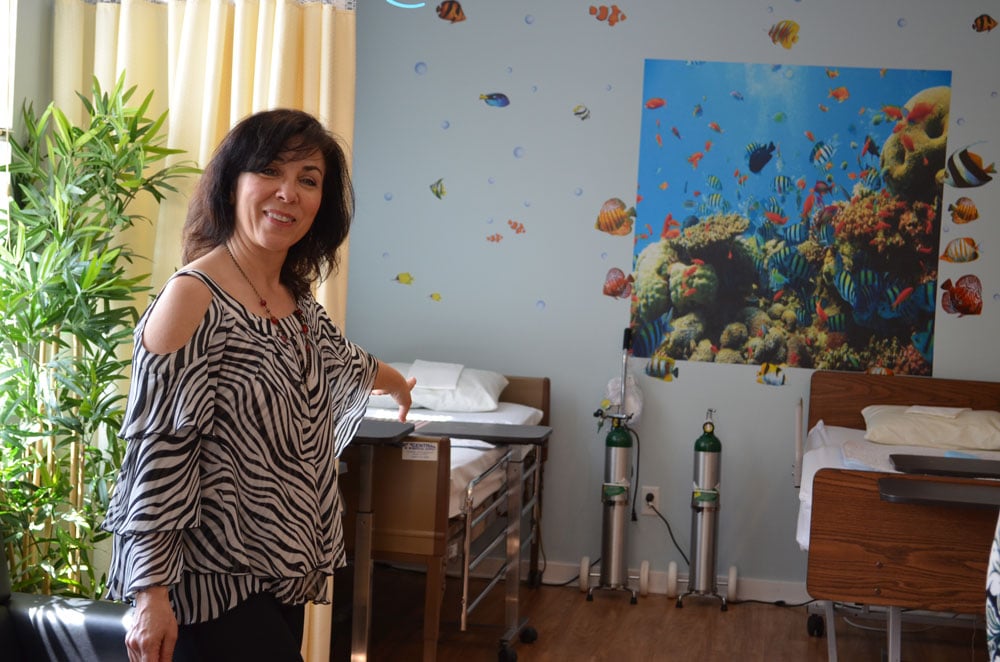 Linda Thomas, the founder of The Parents Group, shows off the Red Ribbon Academy.  The Parents Group is group of five mothers who developed the concept of the Red Ribbon Academy and collaborated with Community Options to open this Medical Special Needs Day Program. Celebrating Two Years of Making a Difference - Community Options’ Red Ribbon Medical Day Program.