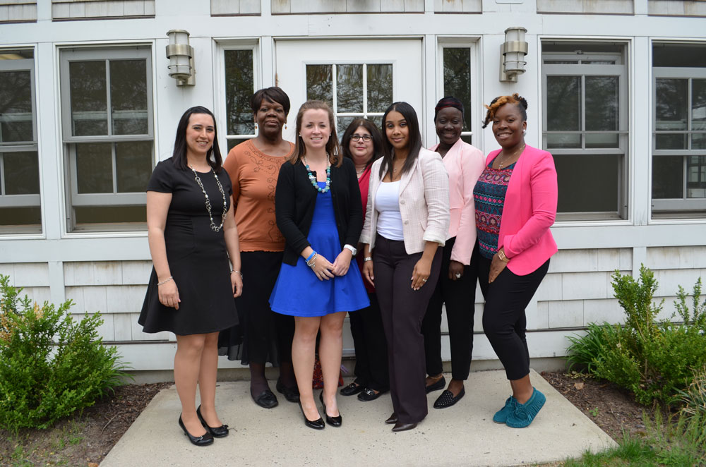 from L to R: Stefanie Rinaldi, Wendy Williams, Meghan Hunter, Deborah Napoleon, Teresa Snyder, Awee Taylor and Keaira Askew of Community Options gather outside Community Options' new STEP building.  The building previously belonged to notable local newspaper, Town Topics.