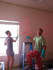 Several volunteers paint Peggy Sue's room in her favorite color, pink.