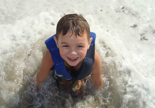 boy in water at imatter surf camp