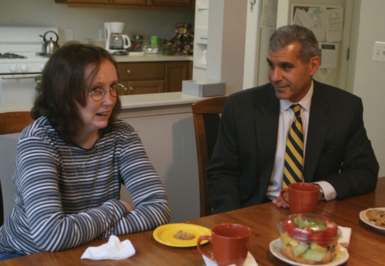 Susan Holston and Senator Joseph Kyrillos enjoy a cup of coffee at her Middletown group home.
