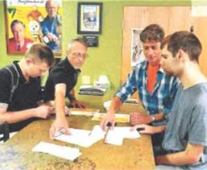 Marc Boyle and Kevin McElhinny volunteer for the Greater Latrobe Laurel Valley Regional Chamber of Commerce stuffing envelopes as part of the Community Integration program. Assisting are Ryan Browne, direct support professional, and Jeff Minkovich, Comm.unity Integration counselor at the Chantber. Photo by Ernie Sistek