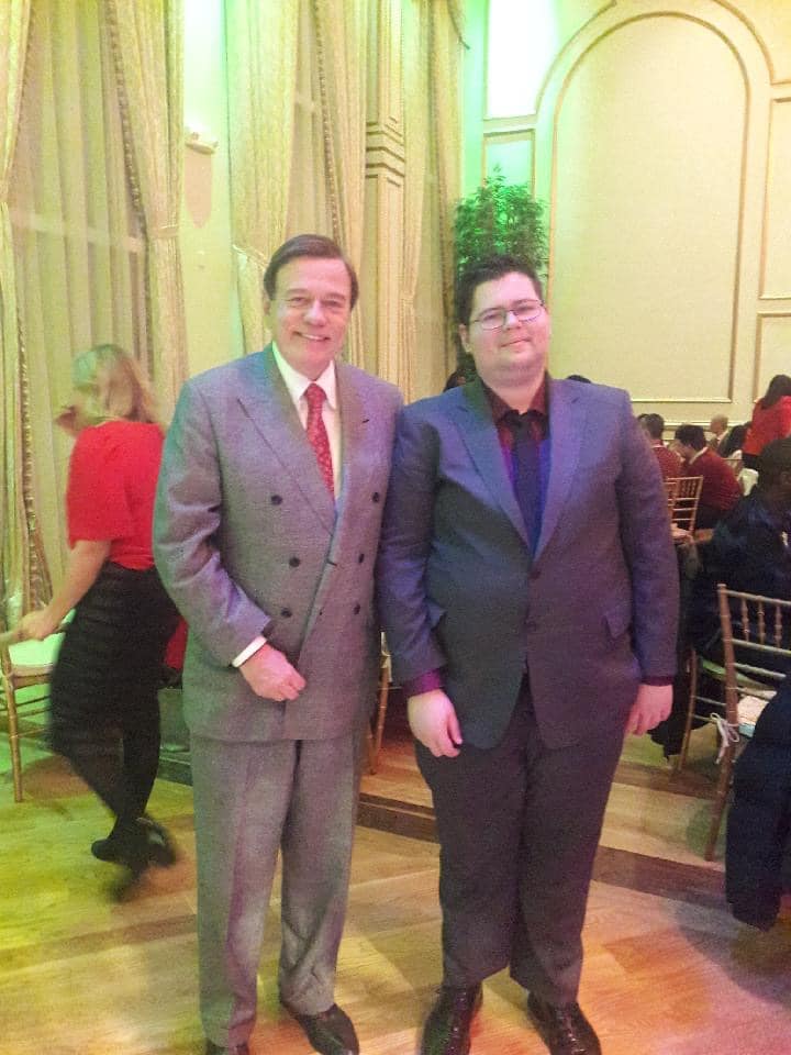 Damian (right) and Community Options President & CEO Robert Stack at the organization's recent holiday party in northern New Jersey.