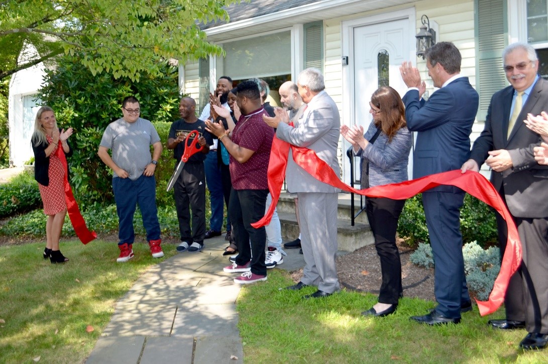Pictured are Svetlana Repic-Qira, Regional Vice President of Community Options; Jack and Ricky, residents of the new home in Princeton, New Jersey; local Community Options staff; New Jersey State Senator Kip Bateman; Princeton Mayor Liz Lempert; New Jersey State Assemblyman Andrew Zwicker; and Philip Lian, Community Options Enterprises Board Chair.