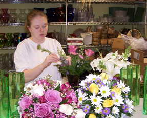Working at vaseful creating a floral arrangement