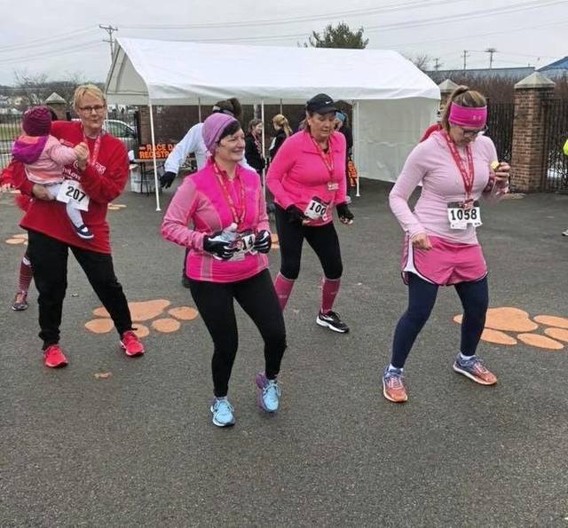Runners warm up before the 2019 Cupid’s Chase charity run at Memorial Stadium in Latrobe. The event raises money to help nonprofit Community Options provide services for adults with intellectual disabilities.