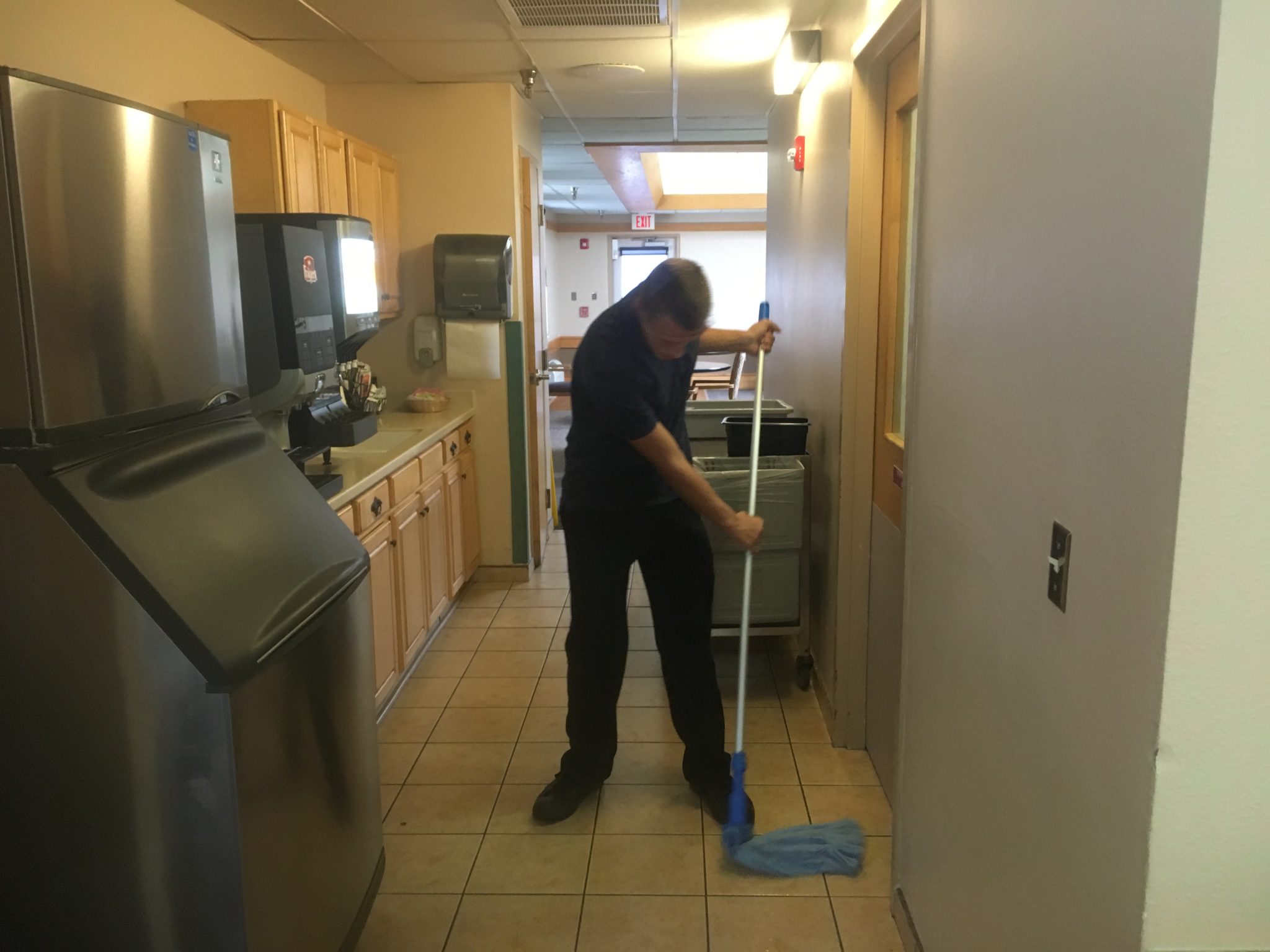 School to work New Mexico individual mopping at work