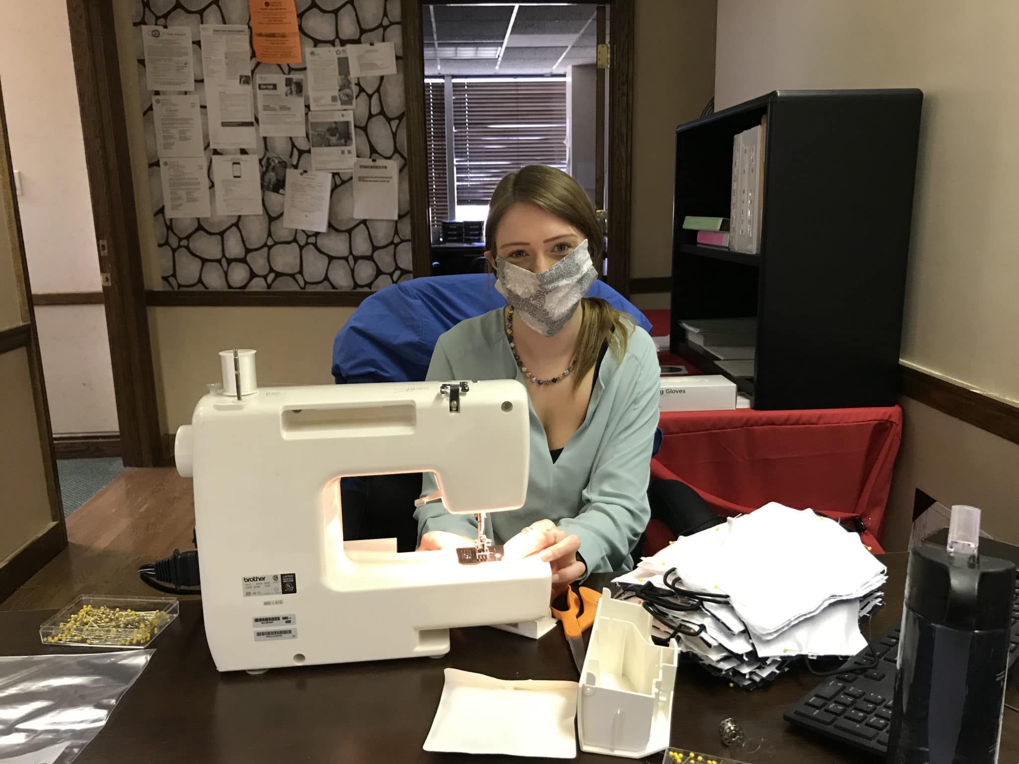 Brooke Smith, the new Administrative Assistant in Washington, PA at her sewing machine sewing masks