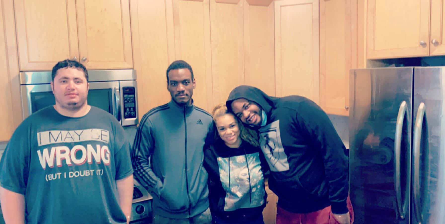 Christian, John, Latoya, and Anthony in the kitchen of a home in NYC