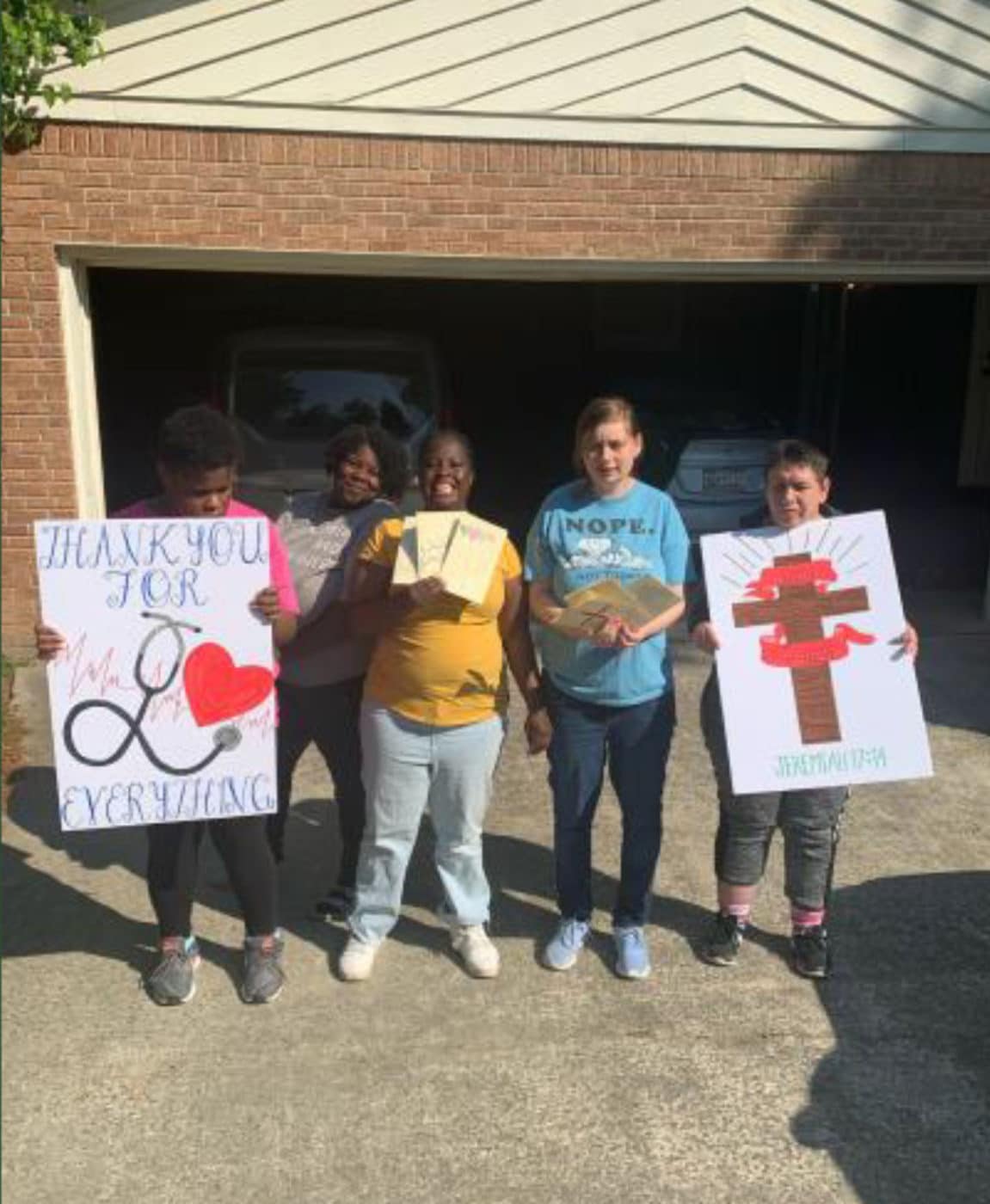 4 people two holding signs Cheering On Lexington Hospital Columbia, SC