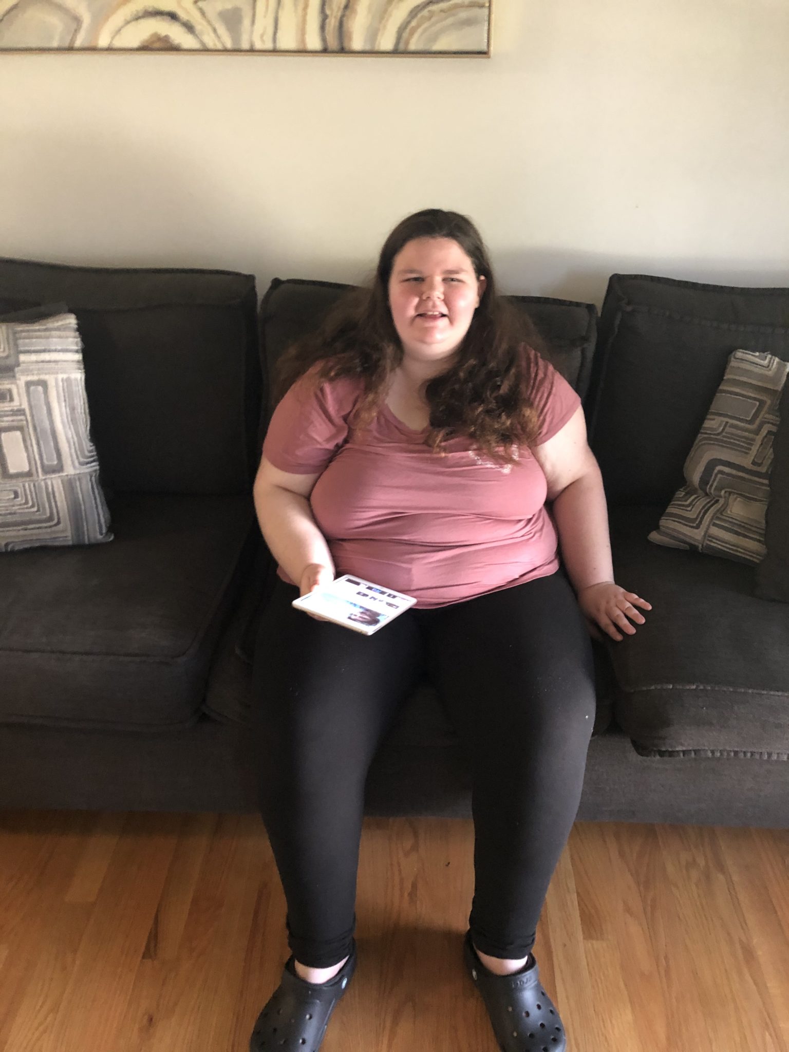 Rachel sitting on a comfy couch