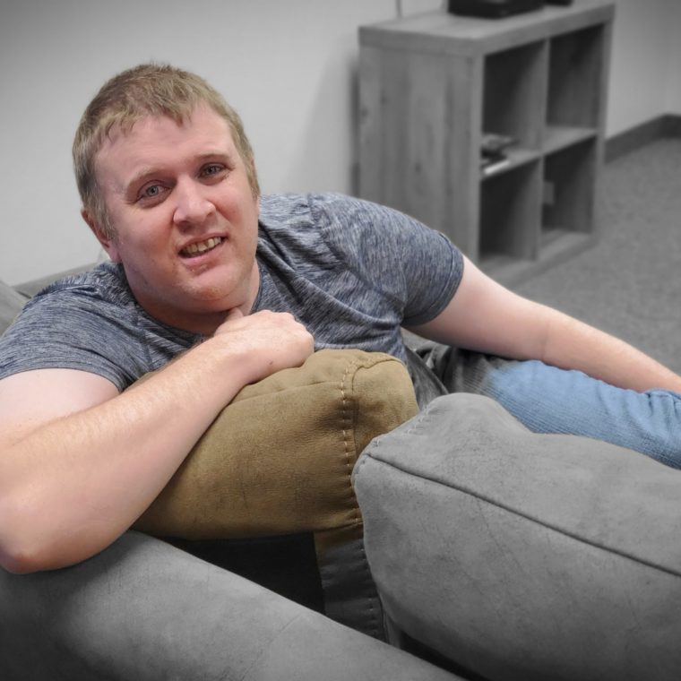 Ryan sitting on a comfy couch