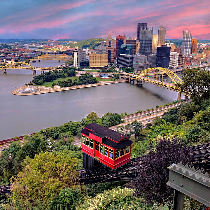 The Duquesne Incline approaches the Mount Washington Station with the downtown Pittsburgh skyline in the background.