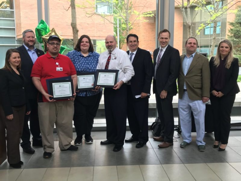 CELEBRATING INCLUSION: At Community Options’ recent ceremony honoring Jovani Rodriguez, Patricia Pavlovsky, and Allen Reigert, those on hand were, from left: Paula Nessler, director of supported employment, Community Options; Assemblyman Dan Benson; Rodriguez, senior food service worker, Aramark; Pavlovsky, assistant program manager, Community Options; Reigert, director of food services, Aramark; Richard Freeman, president and CEO, Robert Wood Johnson University Hospital Hamilton; Hamilton Township Council President Jeff Martin; Scott Crass, constituent services director for Senator Linda Greenstein; and Svetlana Repic-Qira, regional vice president, Community Options.