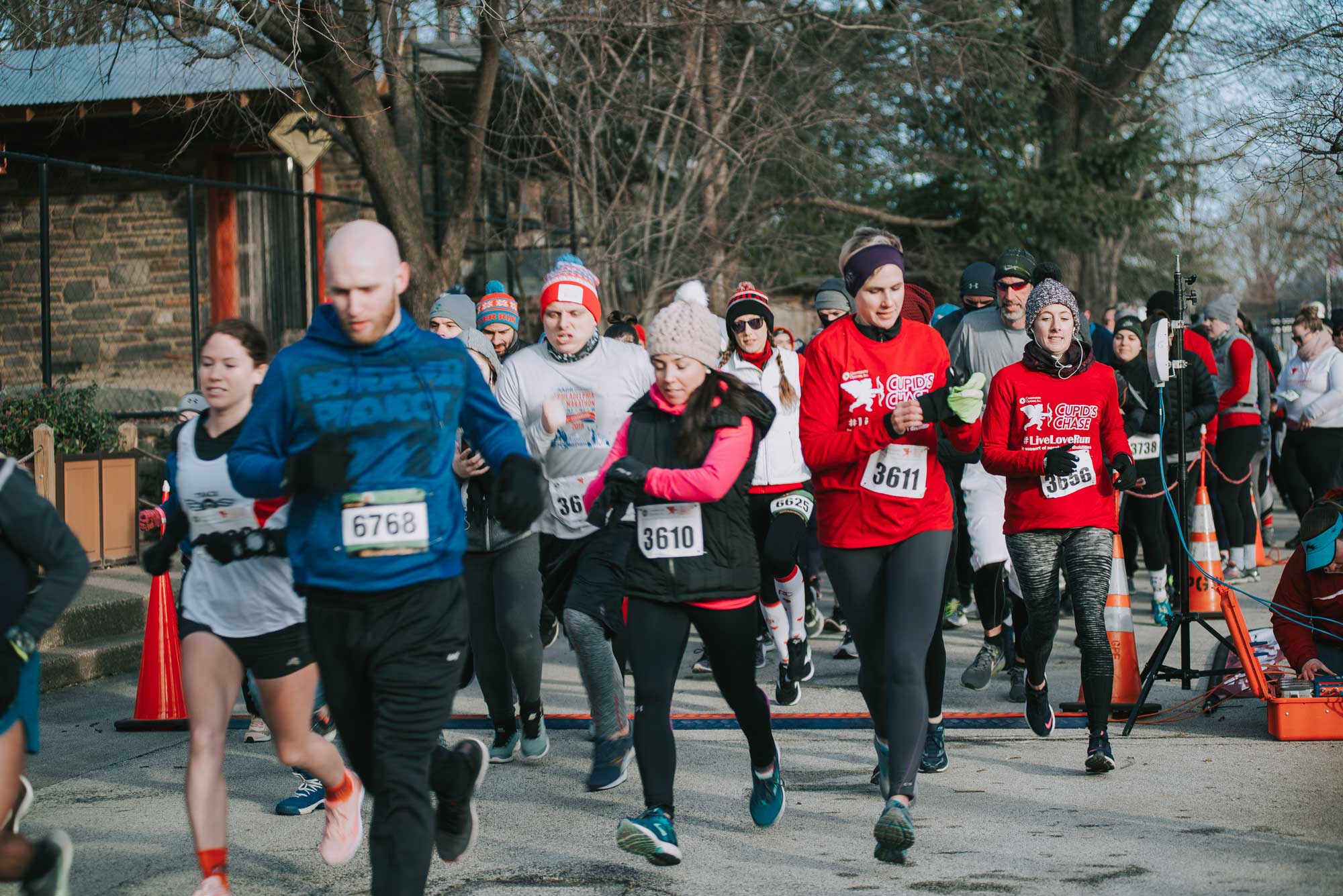 A large pack of runners at a Cupid's Chase 5k