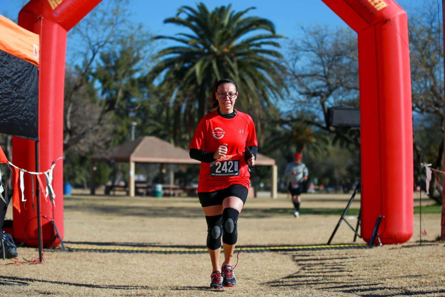 Laura Pina crosses the finish line for the Cupid's Chase 5K Run on February 12, 2022 at Reid Park. Ana Beltran, Arizona Daily Star - tucson.com