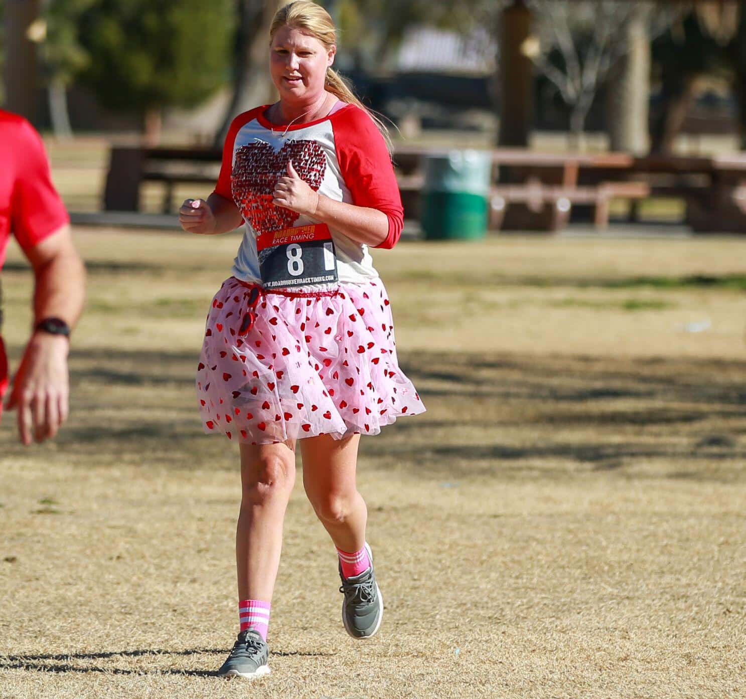 Dee Brady dressed up in Valentine's gear passes the finish line at the Cupid's Chase 5K Run on February 12, 2022 in Reid Park. Ana Beltran, Arizona Daily Star - tucson.com