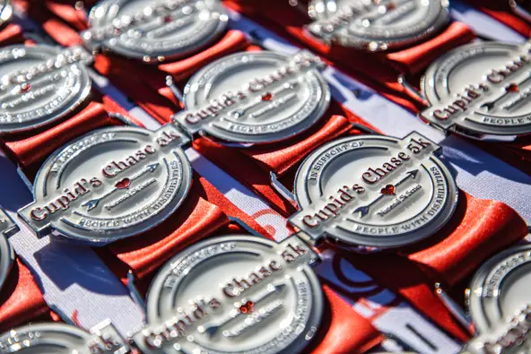 Medals sit on a table at the Cupid's Chase 5K in Mesilla on Saturday, Feb. 12, 2022. Nathan J Fish/Sun-News- lcsun-news.com