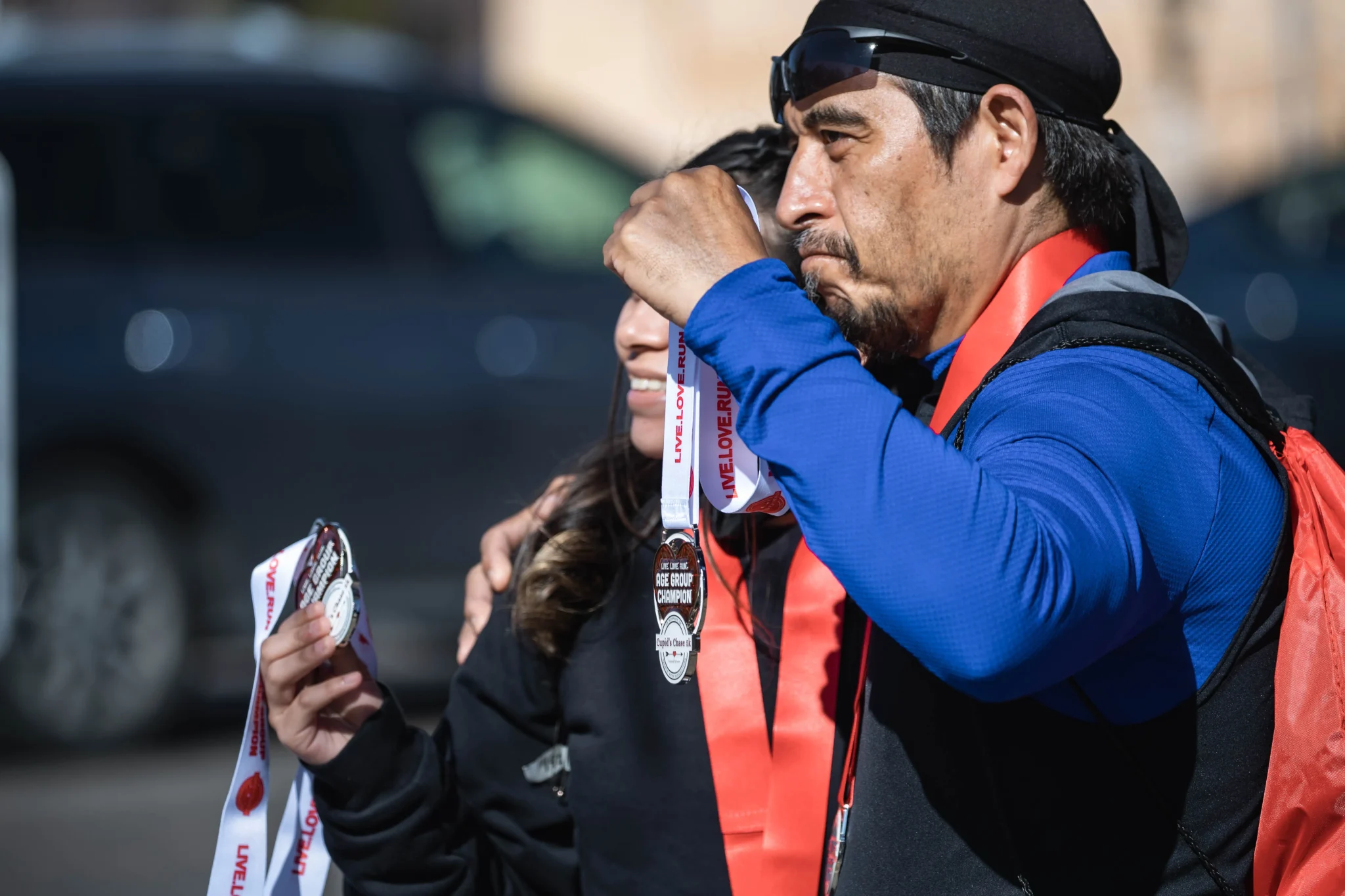 Runners celebrate with their medals at the Cupid's Chase 5K in Mesilla on Saturday, Feb. 12, 2022. Nathan J Fish/Sun-News - lcsun-news.com