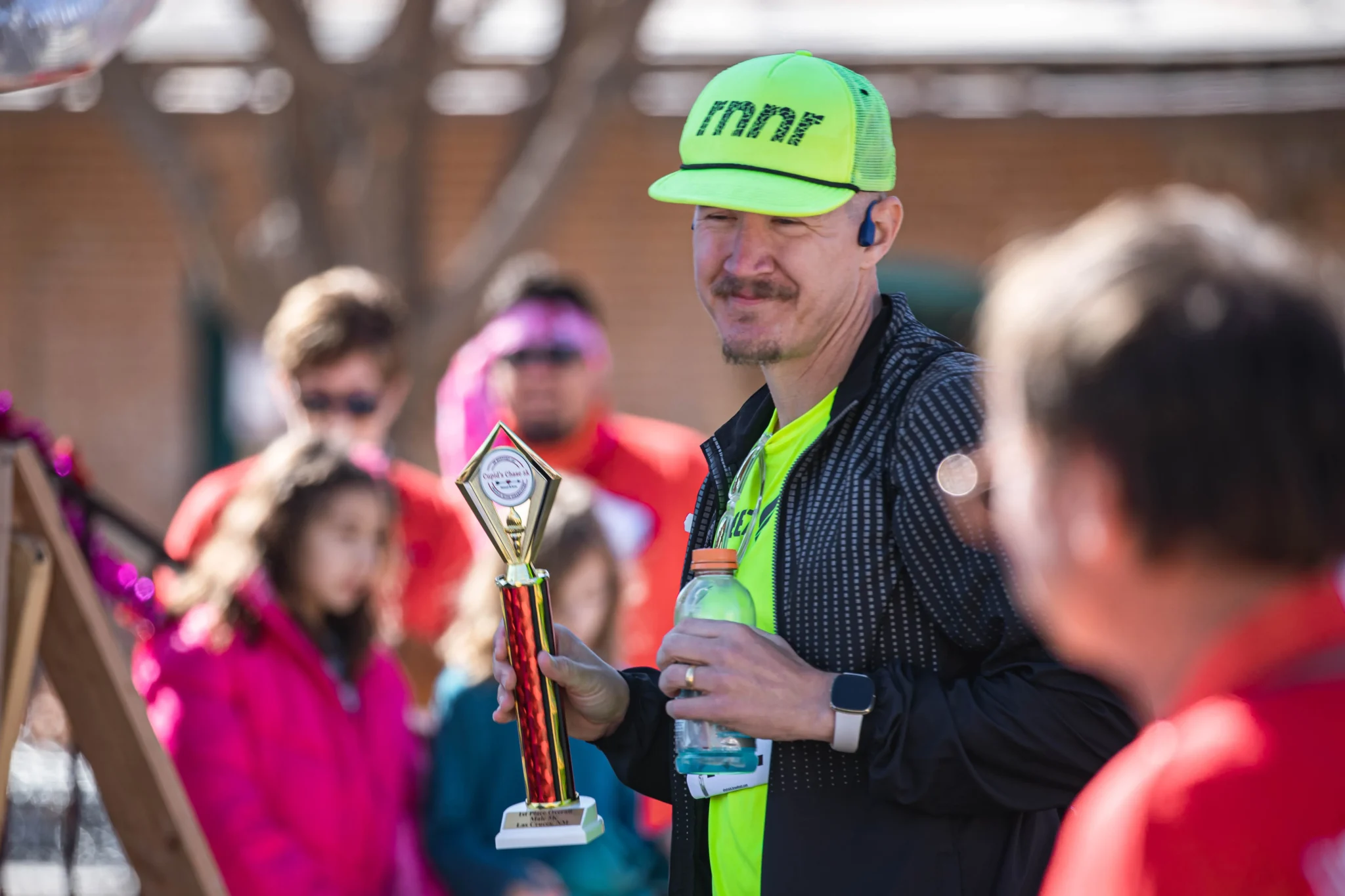 Runners celebrate with their trophies at the Cupid's Chase 5K in Mesilla on Saturday, Feb. 12, 2022. Nathan J Fish/Sun-News - lcsun-news.com