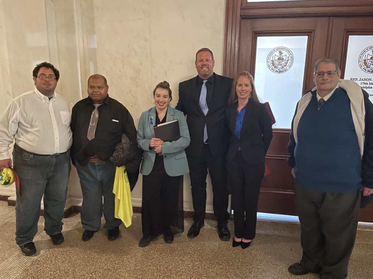 Pennsylvania Representative Jessica Benham, from the 36th district in Allegheny county, was one of the speakers for the press conference. Executives from Community Options Inc. were able to speak with Jessica following the event and support and discuss the need for the increase in wages for Governor Shapiro's budget proposal. Jessica is pictured here with two individuals supported by Community Options Inc.