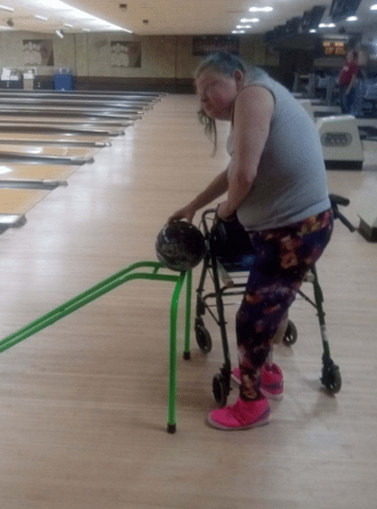 Kat is hoping for a strike as she bowls using her newly adapted walker