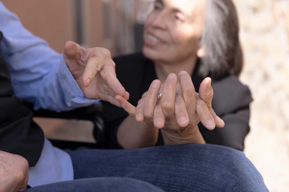 close up showing two peoples hands with finger tips touching