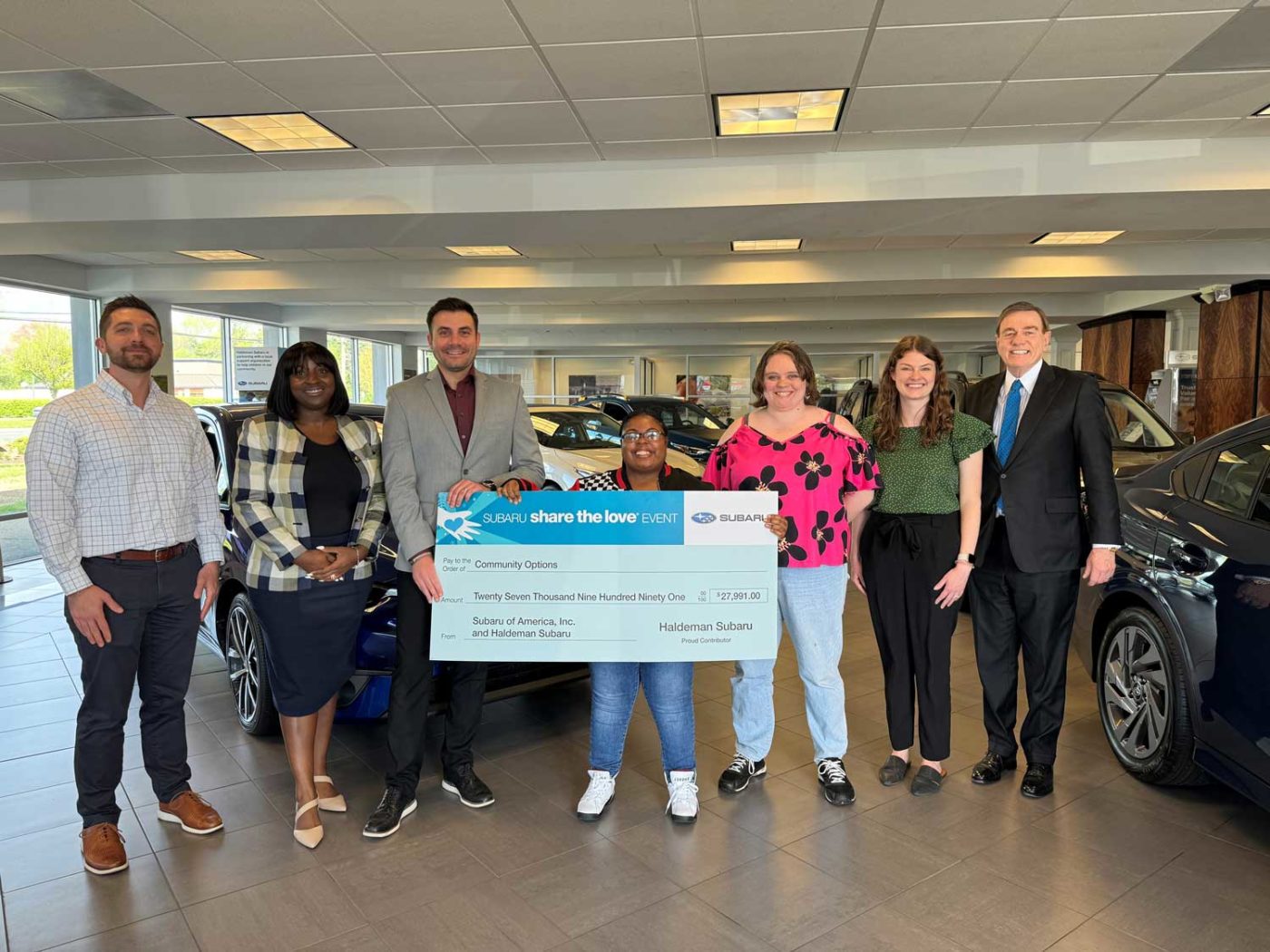 Haldeman Subaru's General Manager, Ken Ruch, along with Courtney Emmolo, the Customer Relations Manager, presented the donation to Robert Stack, President and CEO of Community Options, joined by Ida Bormentar, Executive Director of the Mercer region, and two residents of Mercer County Community Options home, Angelina Rittinger and Terri Devareaux.