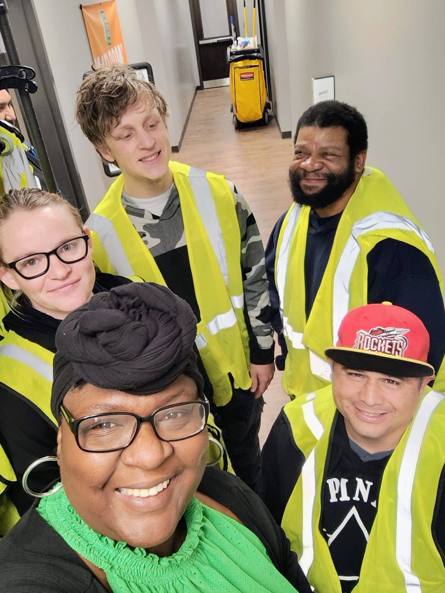 Cayden, Jesse and John donning their safety vests and smiles ready for their first day volunteering with Rhonda Bible from Community Options Inc, at the South Plains Food Bank in Lubbock, TX.