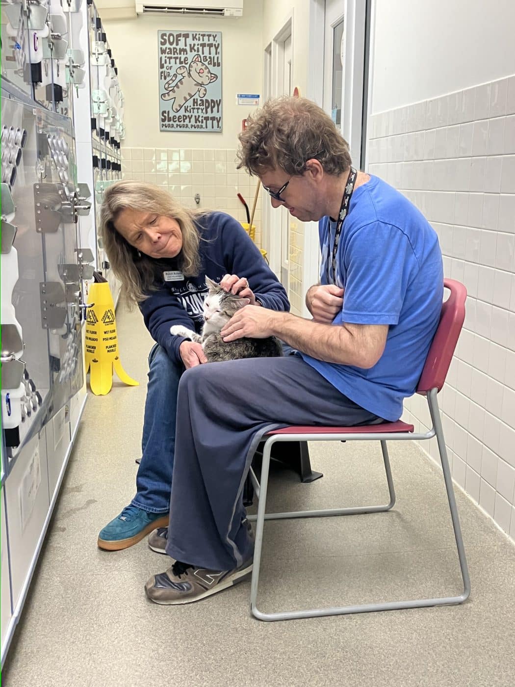 Robin Avison, Lead Volunteer at the Nashville Humane Association has been said to be happy to share her kitty knowledge. Here she is sitting with Ryan and an adorable patched tabby cat.