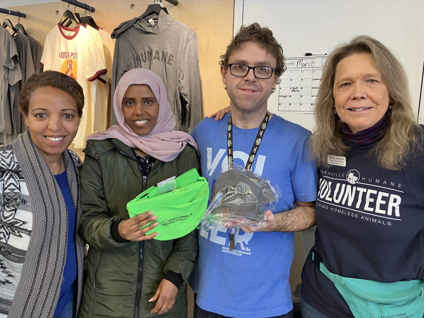 Kedija, Seble, Ryan and Robin showing off some of the Nashville Humane Association merch that supports shelter pets.