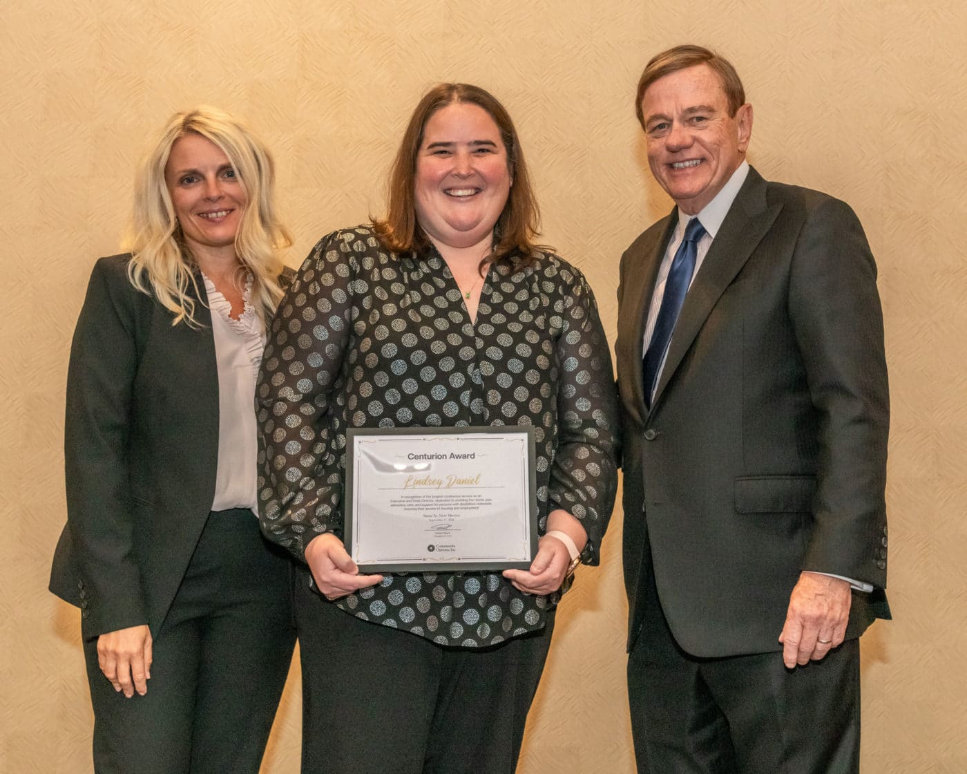 Lindsey Daniel proudly accepts the prestigious Centurion Award from Svetlana Repic-Qira and Robert Stack
