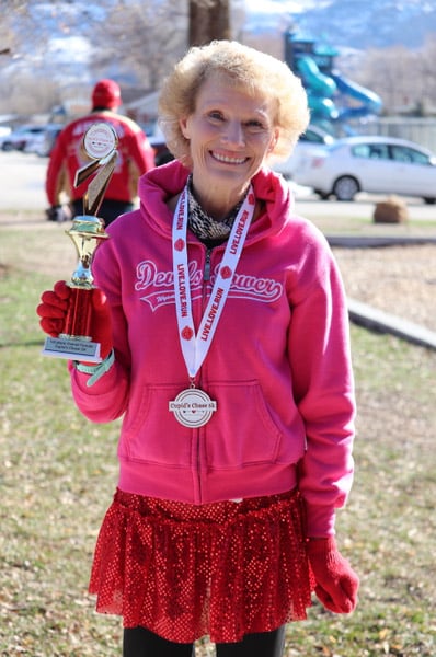 A racer from the 2024 Ogden race shows off her trophy for first place female overall. Two races in Utah will be hosted at Sugar House Park in Salt Lake City and Lorin Farr Park in Ogden to raise funds for the organization and local individuals.