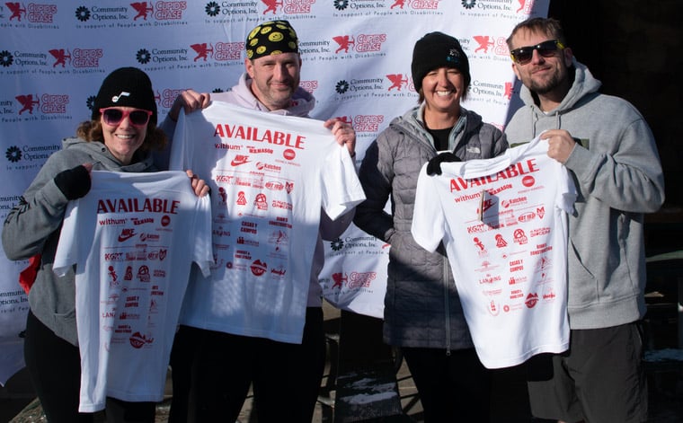Runners posing holding up Available tee shirts