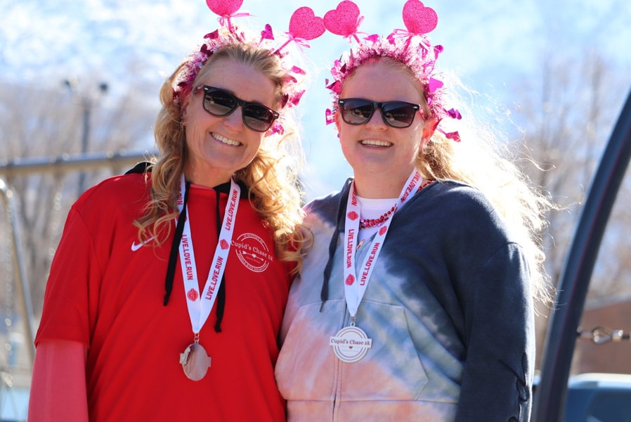 Two runners wearing heart headbands