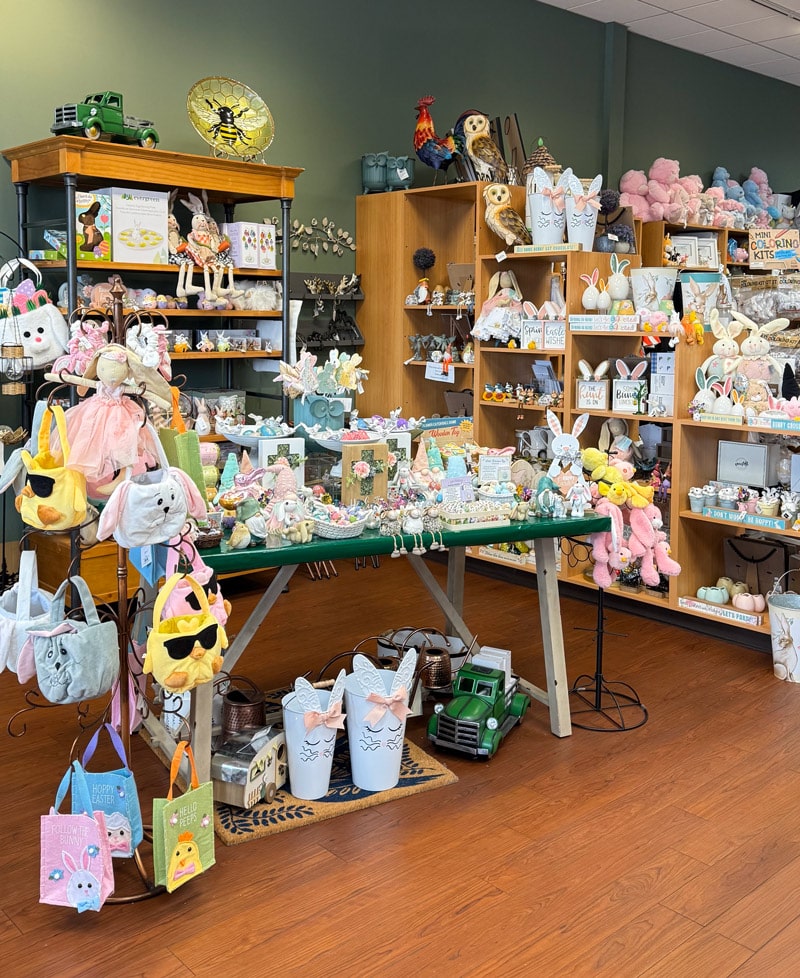 An Easter-themed display at Presents of Mind gift shop featuring pastel-colored decorations, bunny figurines, and festive springtime gifts. Shop unique Easter décor and gifts while supporting employment for people with disabilities. Located at 240 US-206, Flanders, NJ 07836. Shop online at presentsofmind.org.
