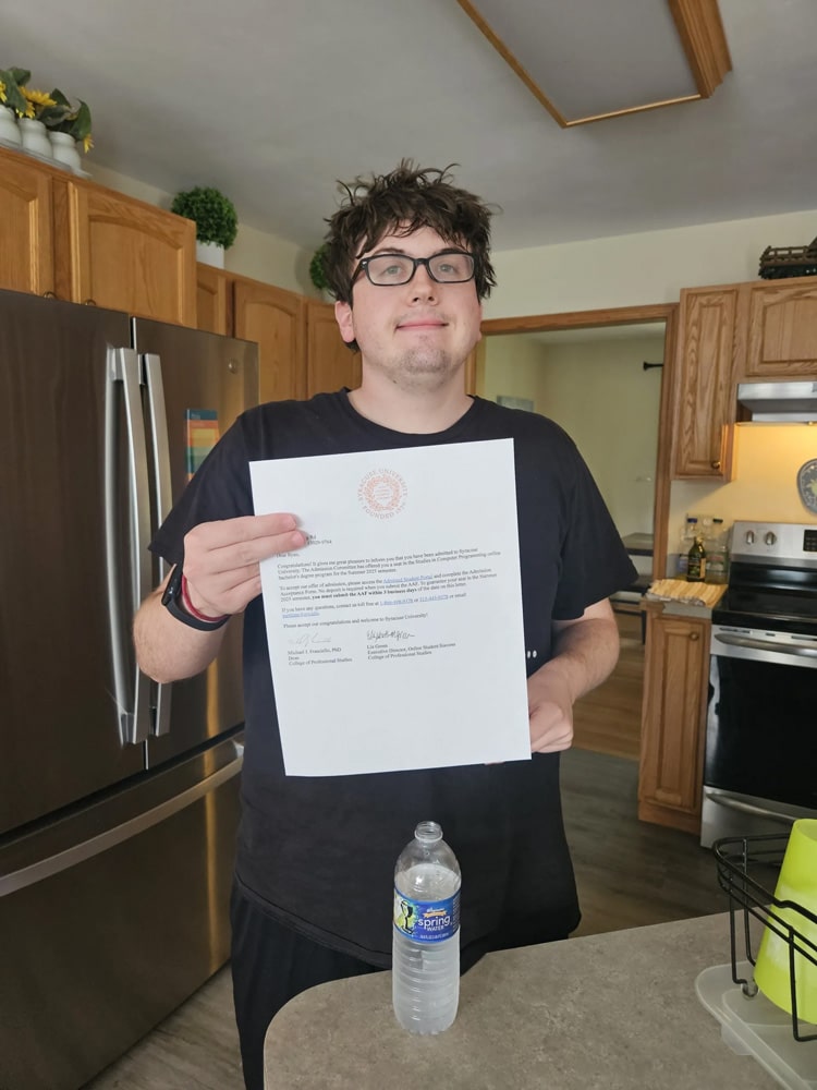 Ryan with his acceptance letter to Syracuse University.