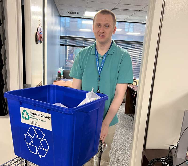 Peter HR Clerk - Passaic County Human Resources Department. Peter is seen with a paper recycling bin.