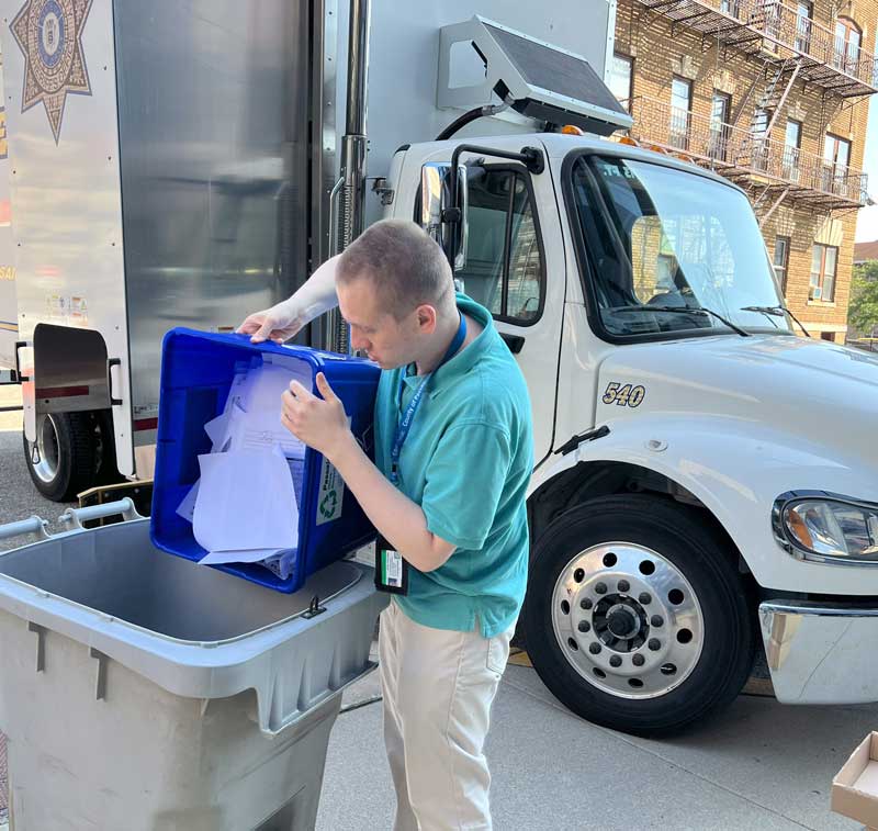 Peter HR Clerk - Passaic County Human Resources Department. Peter is seen emptying paper recycling.