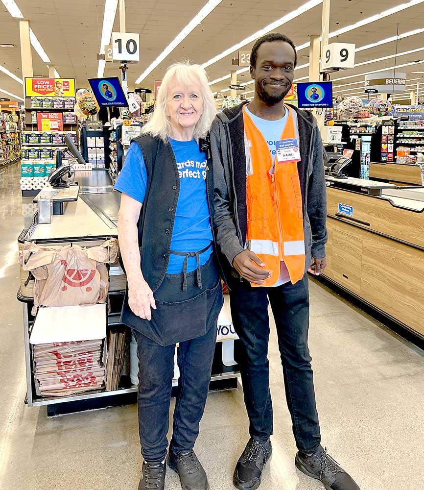 Natali and his manager, Kim, smile and celebrate Natali’s success at his new job.