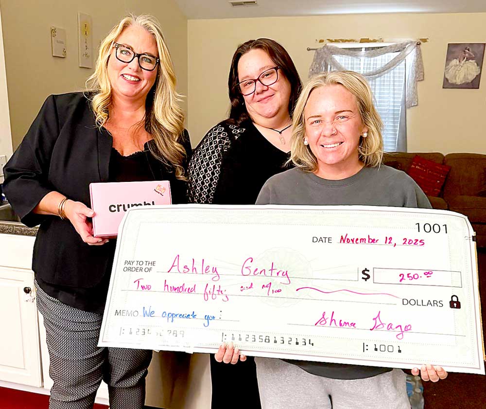 Shana Gago, left, and Program Manager Ryanne McBride, center, presented Ashley Gentry, right, with the Intrepid Award for her above-and-beyond service and dedication.