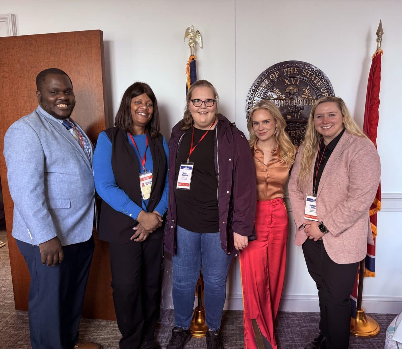 ftyn stands with Antonio, Marie, and Mercedes during a meeting with Community Options in Tennessee.