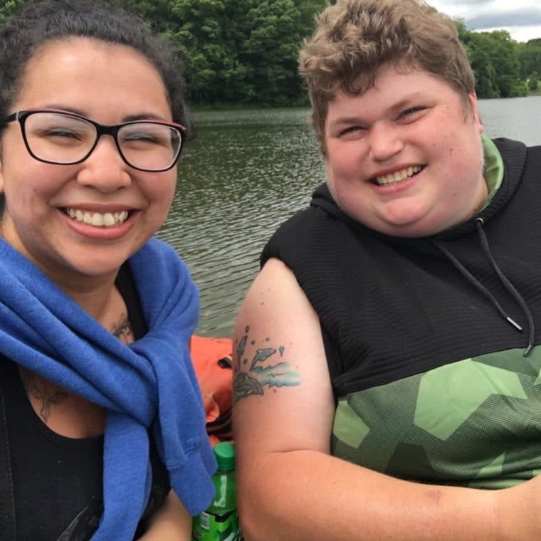 Ana Sholock And BJ Together on a padilling boat with big smiles.