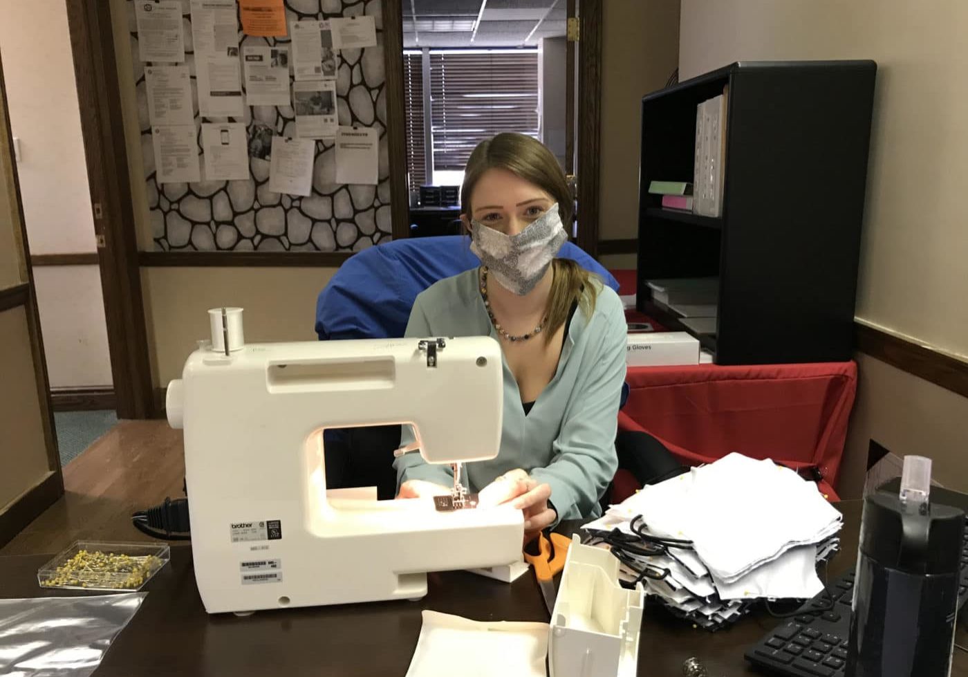 Brooke Smith, the new Administrative Assistant in Washington, PA at her sewing machine sewing masks