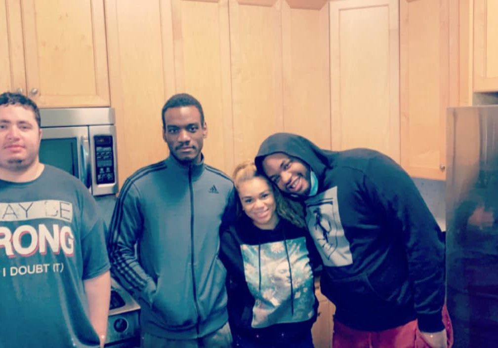 Christian, John, Latoya, and Anthony in the kitchen of a home in NYC