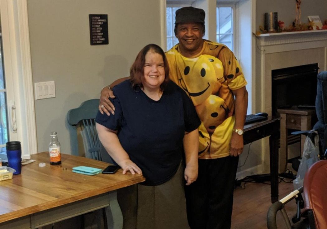 A woman standing with Leon Howze