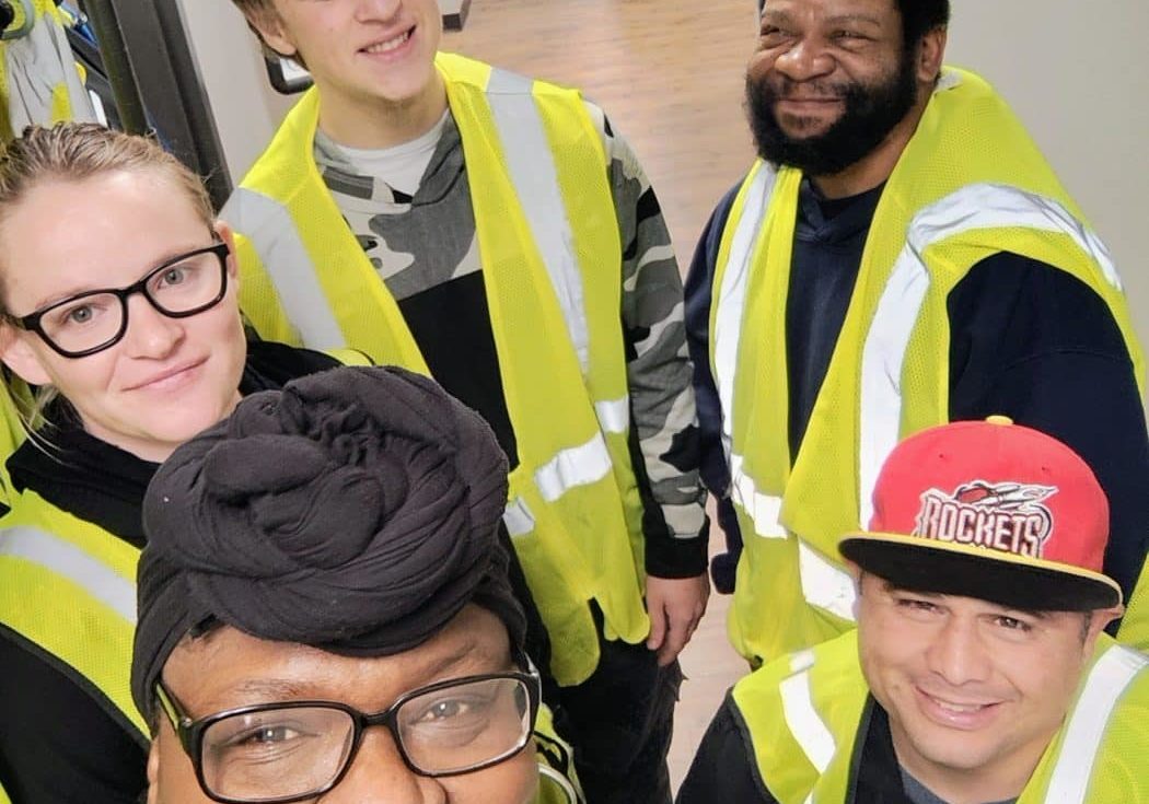 Cayden, Jesse and John donning their safety vests and smiles ready for their first day volunteering with Rhonda Bible from Community Options Inc, at the South Plains Food Bank in Lubbock, TX.