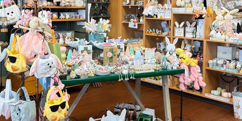 An Easter-themed display at Presents of Mind gift shop featuring pastel-colored decorations, bunny figurines, and festive springtime gifts. Shop unique Easter décor and gifts while supporting employment for people with disabilities. Located at 240 US-206, Flanders, NJ 07836. Shop online at presentsofmind.org.